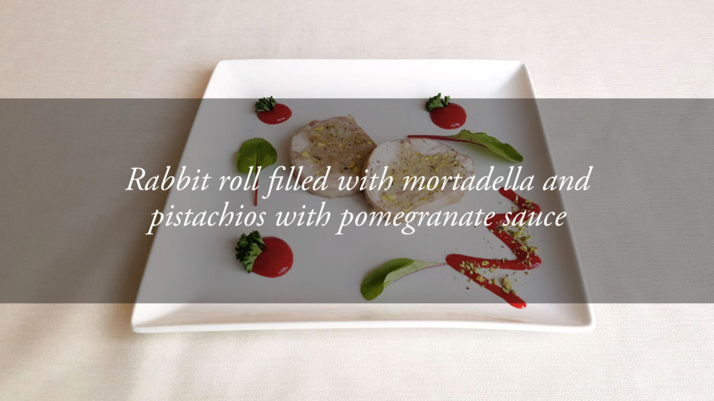 The specialities of the chef: filled rabbit roll with pomegranate sauce