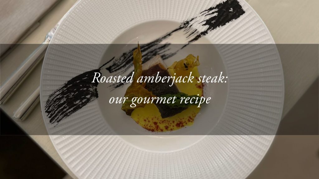 A gourmet recipe: slice of roasted amberjack in cuttlefish ink, with asparagus, courgette flowers and saffron sauce